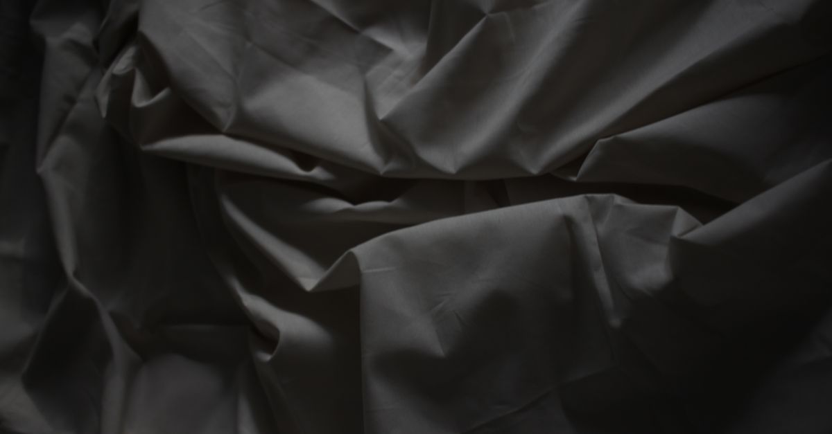 A map of a fictional city emerging from a flat clothing brand lookbook under dark light