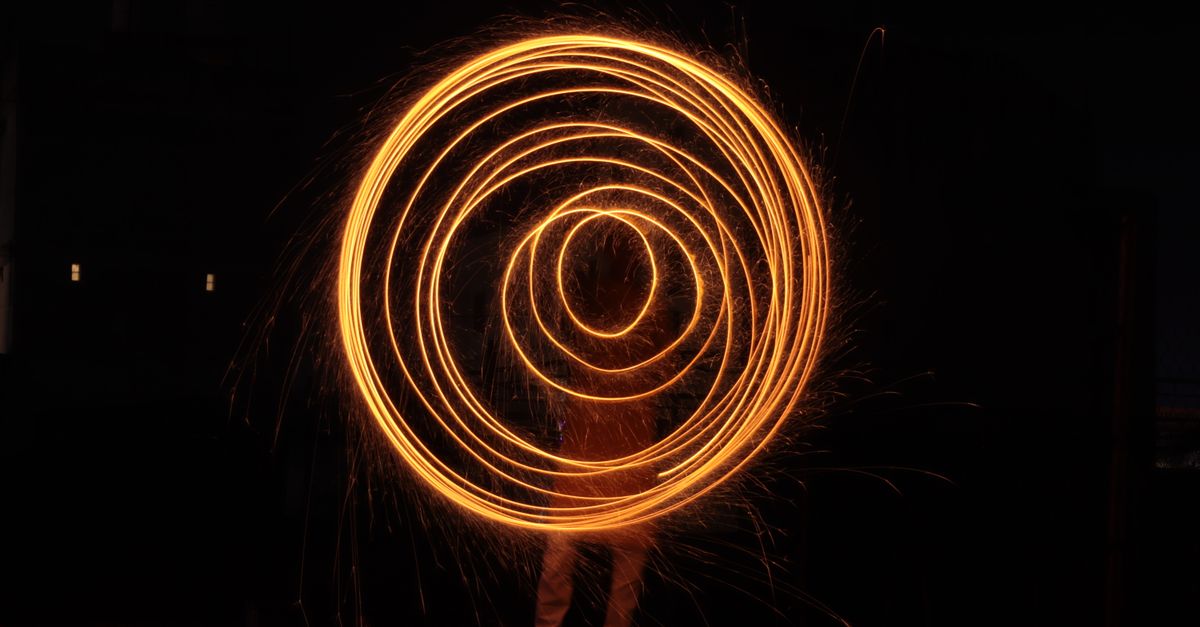 A complete circle of light against darkness, wholeness across every axis with no gap left to grab