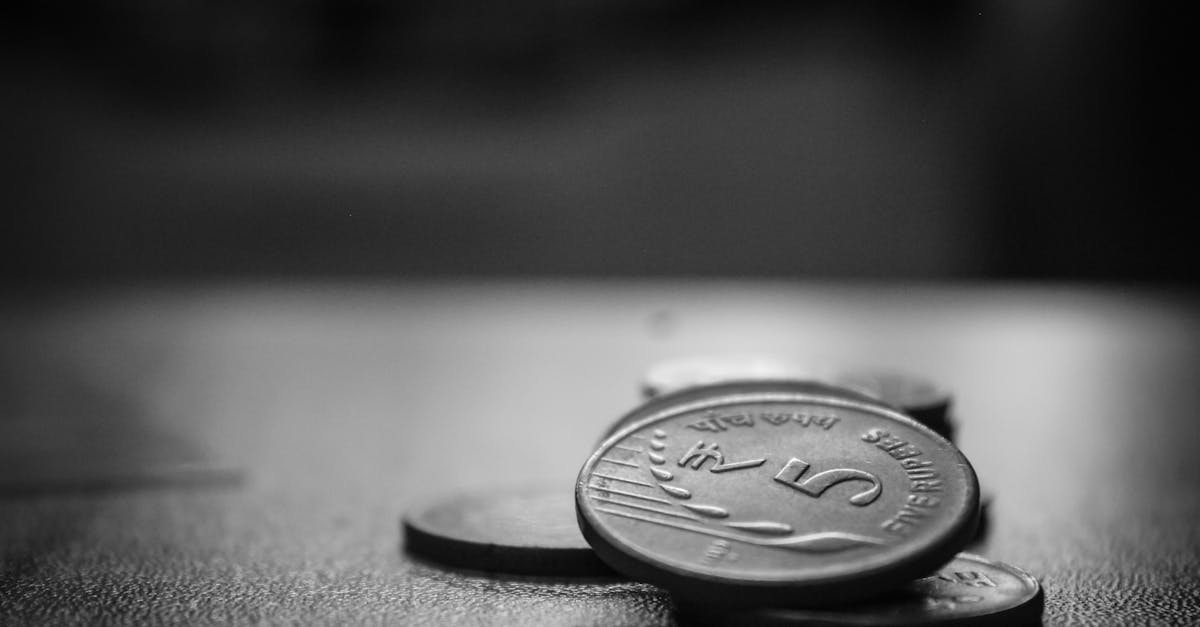 Coins in deep shadow, representing money reclaimed as a tool rather than a master