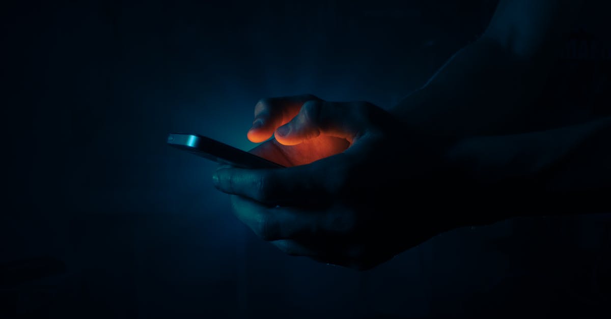 A hand lit only by the glow of a phone in the dark, convenience as a quiet leash