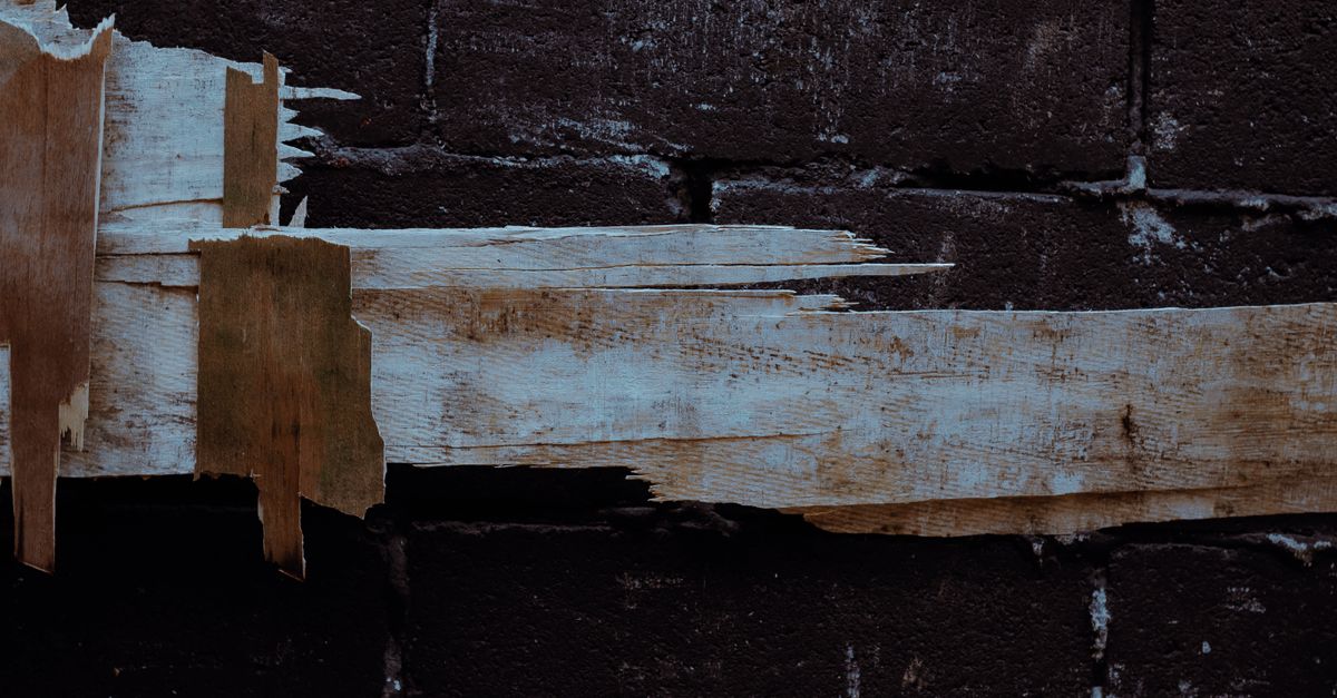 Figure at a threshold of light and shadow as an inherited framework stops fitting