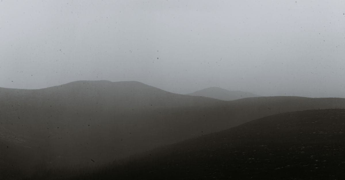 A quiet misty mountain at dawn, representing depth and silence over market noise
