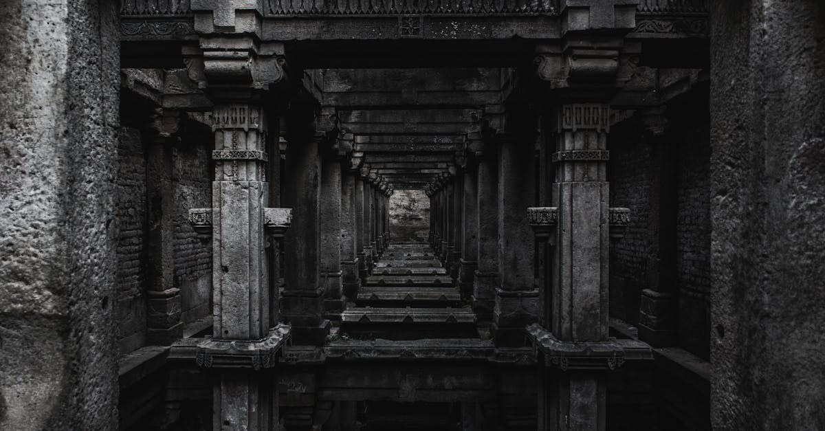Dark monolithic gateway into Ytinu City under a starless sky, the founding filter