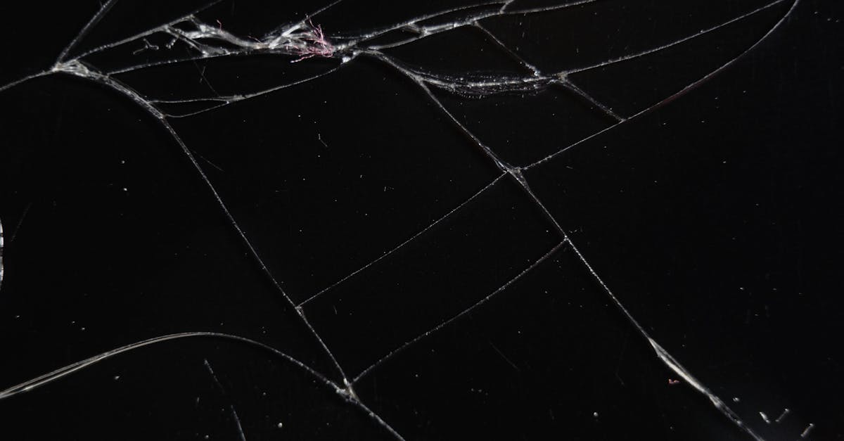 A fractured mirror reflecting a dim face in pieces, identity broken into sellable parts