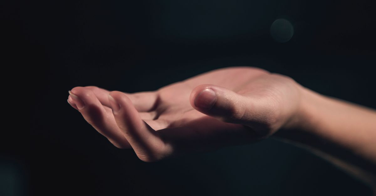 Two open hands reaching toward light, representing the choice to serve people rather than use them