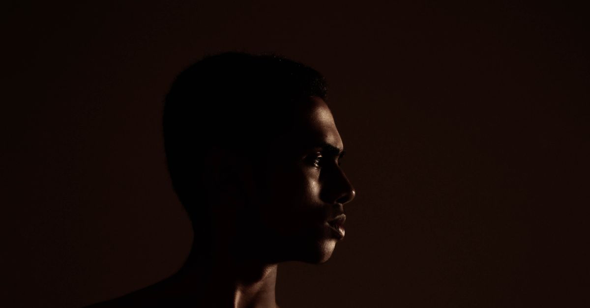 A human silhouette stepping toward light, representing a pro-human system built to serve people