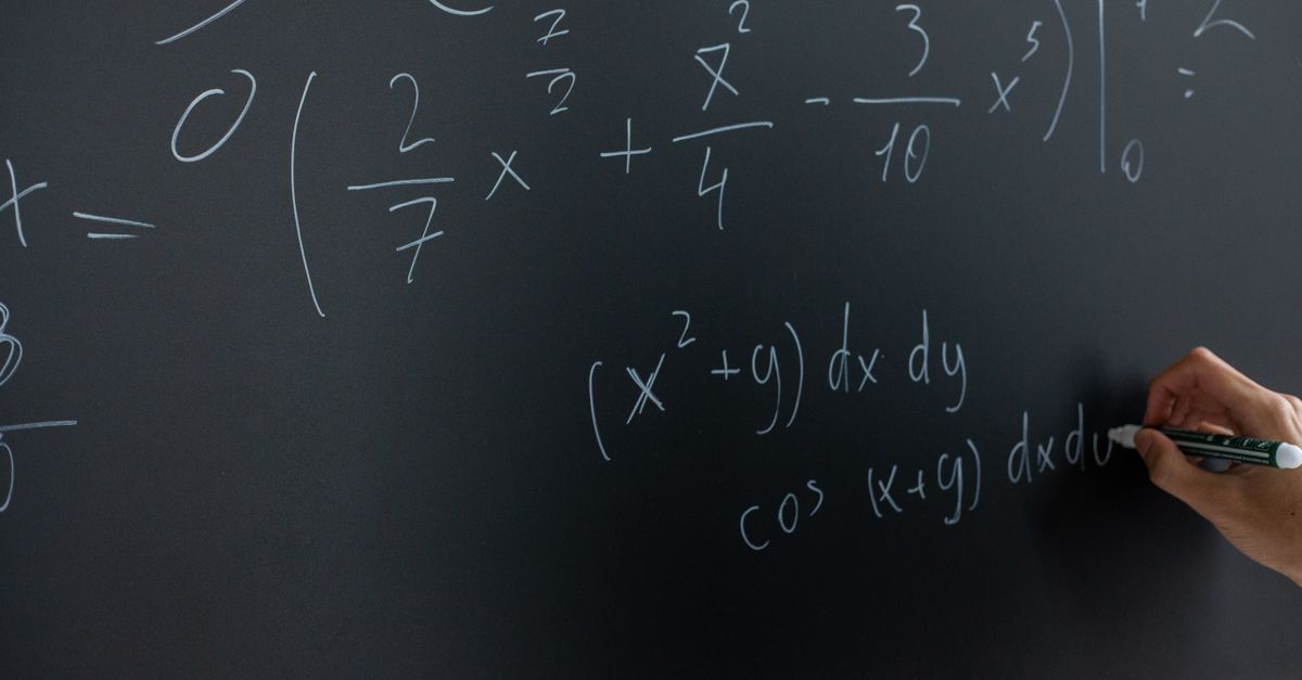 A dark chalkboard covered in an unbalanced equation and sacred-geometry diagrams